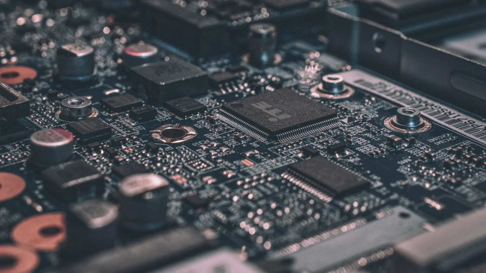 Close-up of a green circuit board with chips and traces