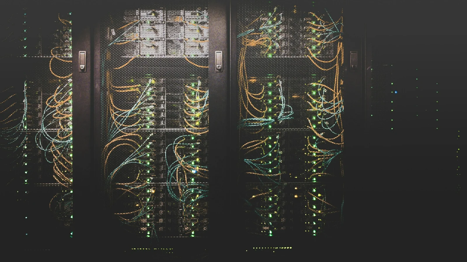 Rows of server racks with blue status lights in a data centre
