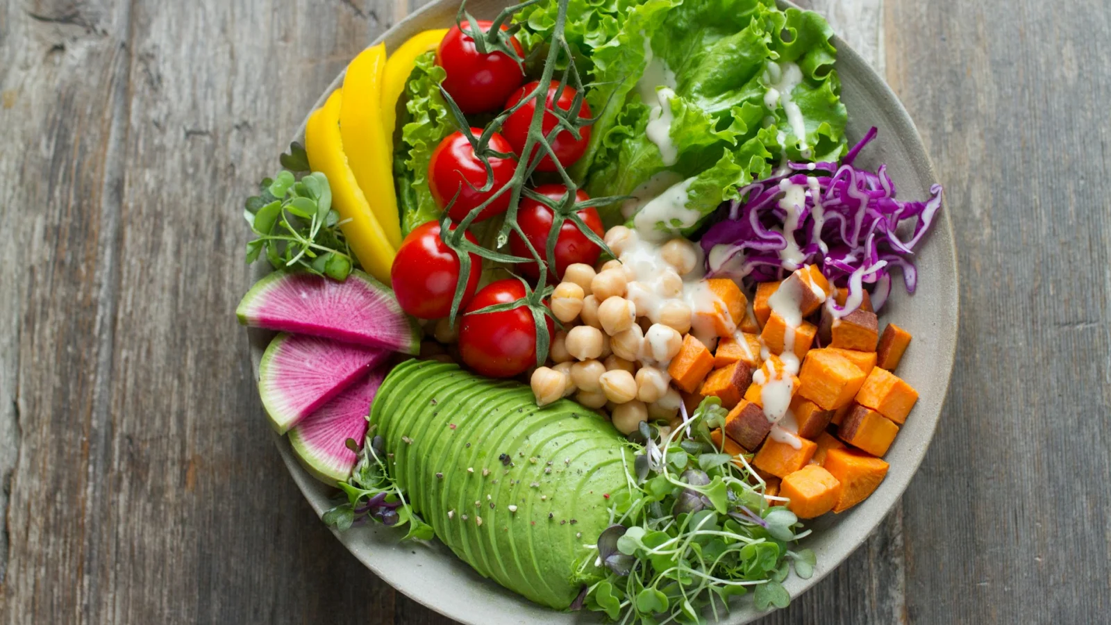 Bowl of salad with vegetables, grains and avocado