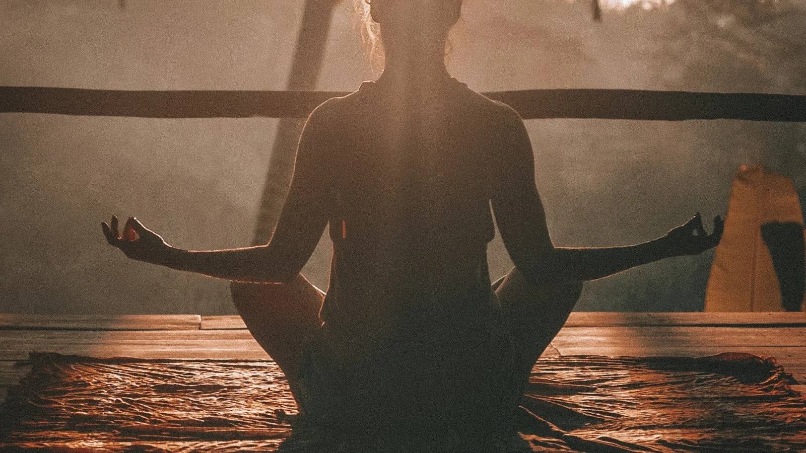 Person meditating in warm evening light