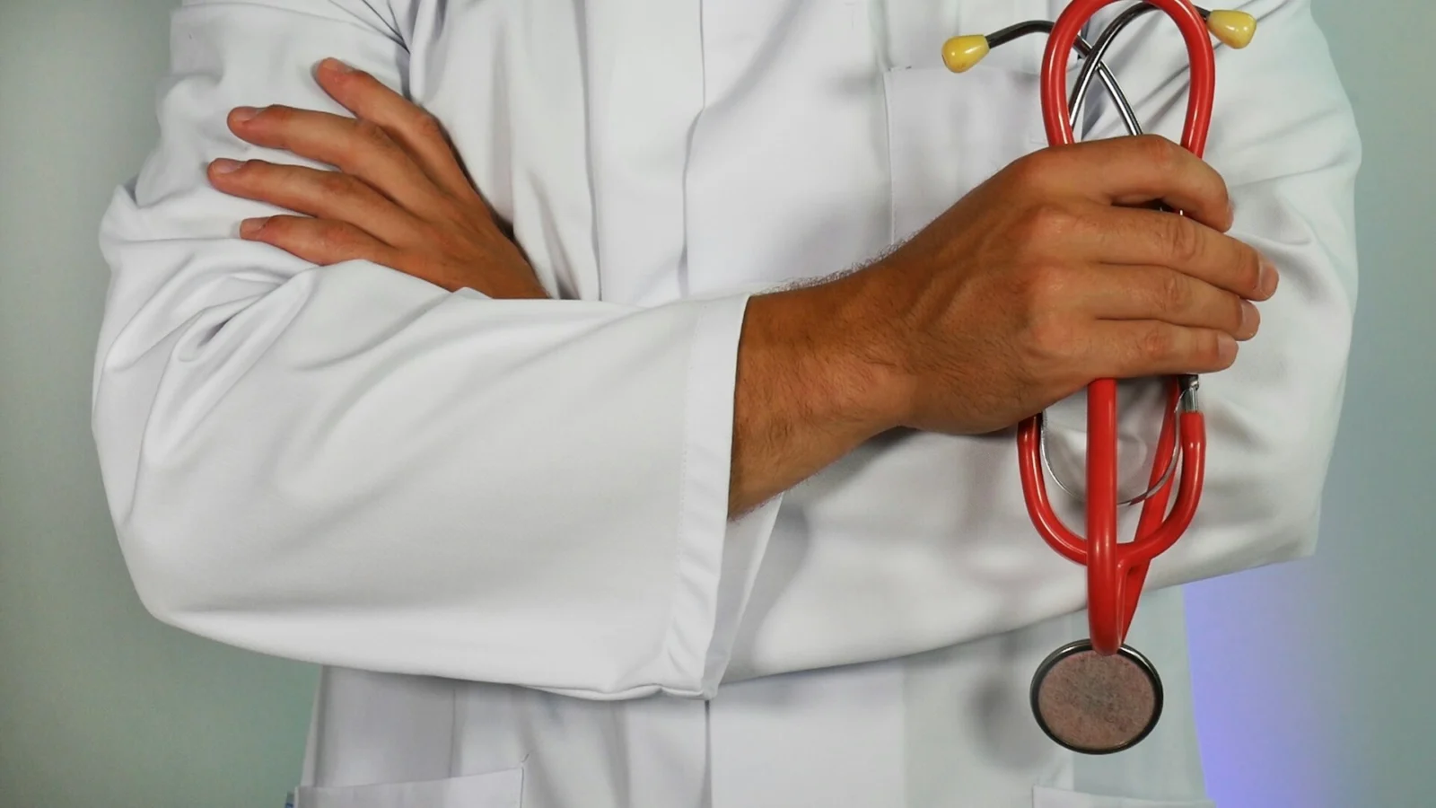 Doctor in a white coat holding a stethoscope