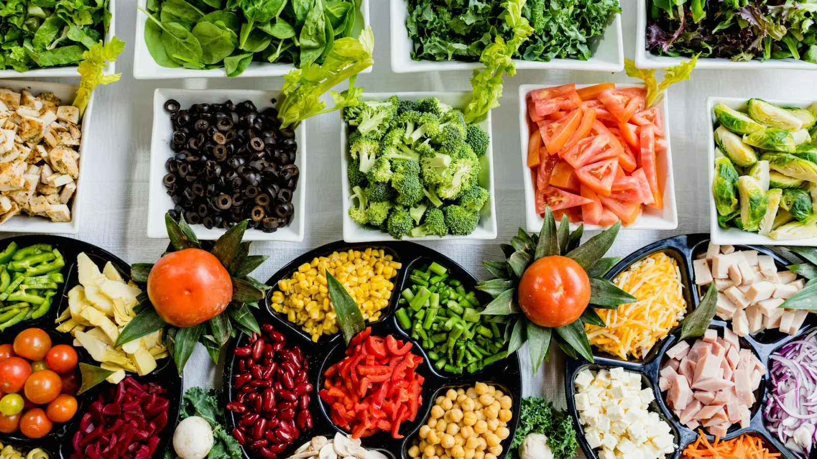 Containers of prepared vegetables, grains and fruit on a table