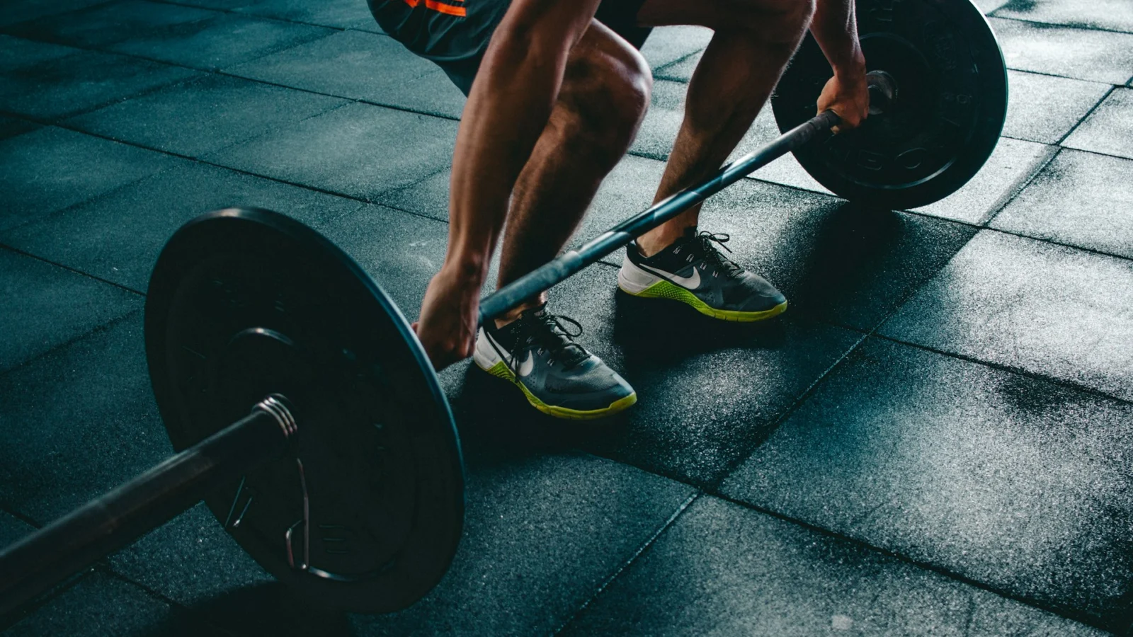 Person lifting a loaded barbell in a gym
